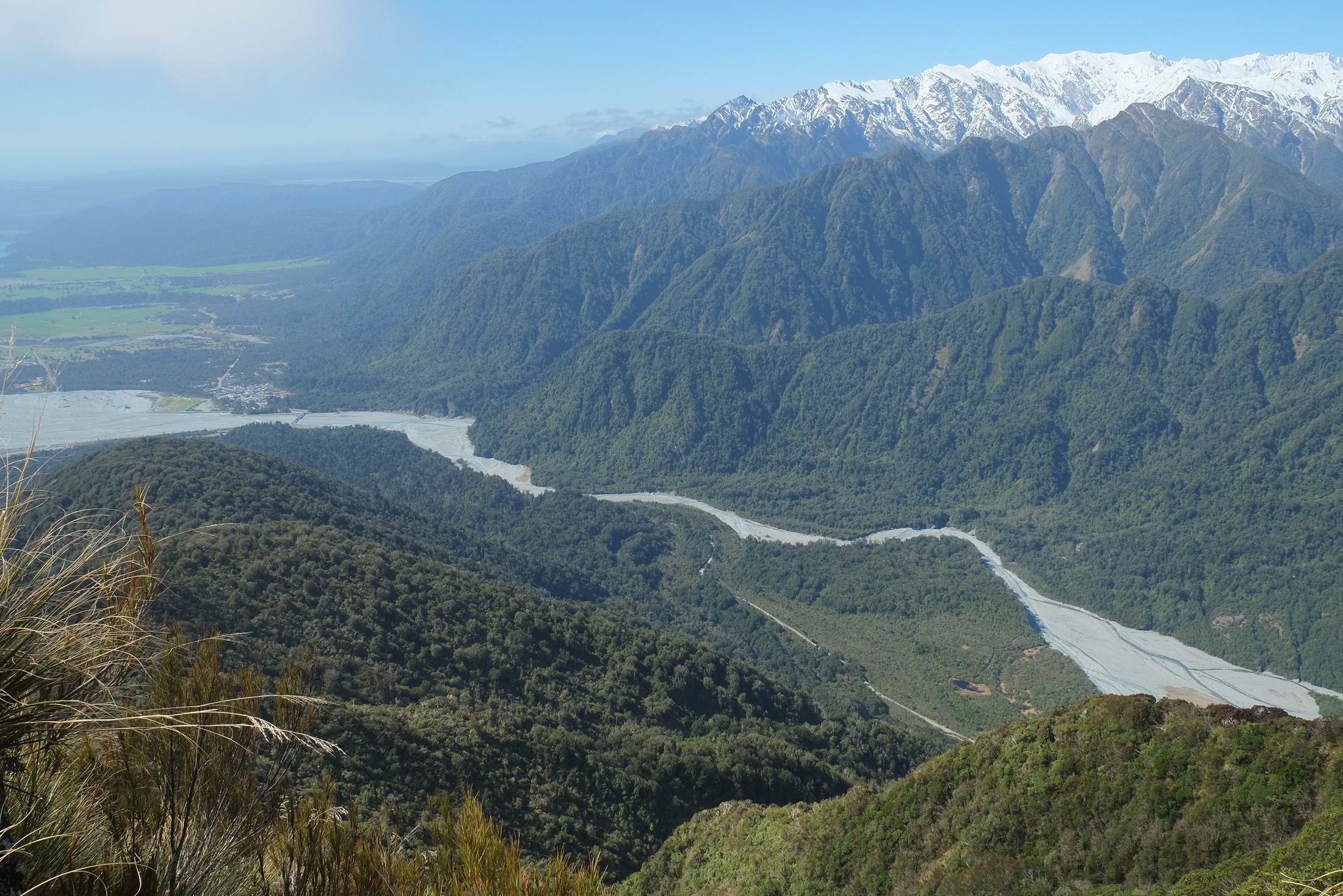 Franz Josef village and valley from Alex Knob, with the river bed of Waiho River clearly visible in the valley below. | Franz Josef in New Zealand